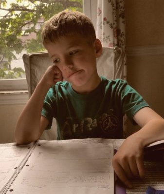 sad boy with homework